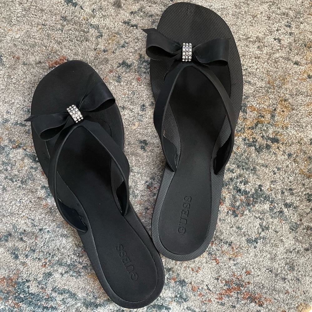 Guess women’s flip flops with bow and rhinestones.  Size 8
